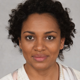 Joyful black adult female with short  brown hair and brown eyes