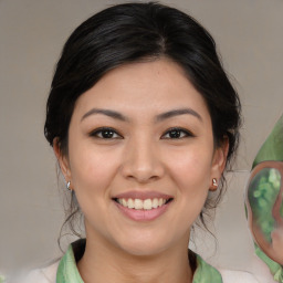 Joyful asian young-adult female with medium  brown hair and brown eyes