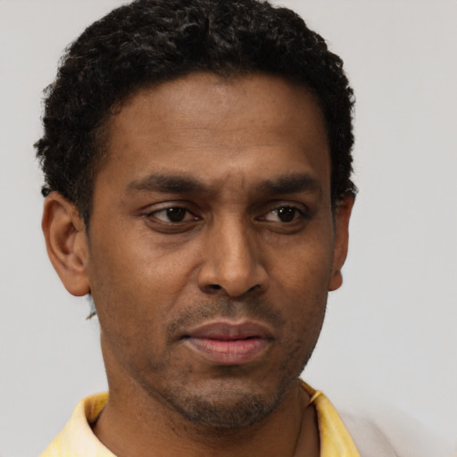 Neutral latino young-adult male with short  brown hair and brown eyes
