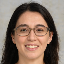 Joyful white adult female with long  brown hair and brown eyes