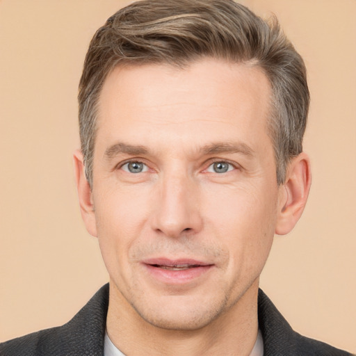 Joyful white adult male with short  brown hair and grey eyes