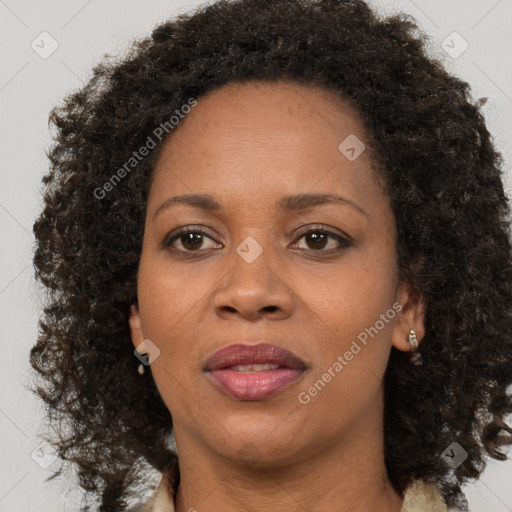 Joyful black adult female with medium  brown hair and brown eyes