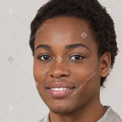 Joyful black young-adult female with short  brown hair and brown eyes