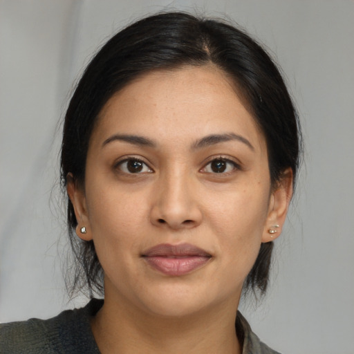 Joyful asian young-adult female with medium  brown hair and brown eyes