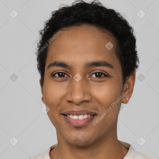 Joyful latino young-adult male with short  black hair and brown eyes