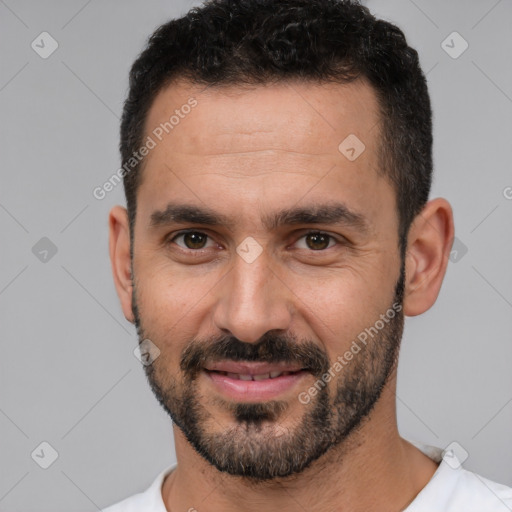 Joyful white young-adult male with short  black hair and brown eyes