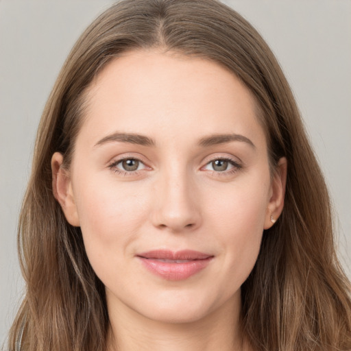 Joyful white young-adult female with long  brown hair and grey eyes