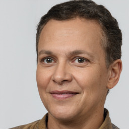 Joyful white adult male with short  brown hair and brown eyes