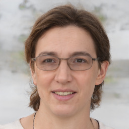 Joyful white adult female with medium  brown hair and grey eyes