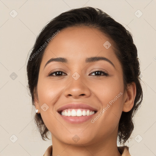 Joyful latino young-adult female with long  brown hair and brown eyes