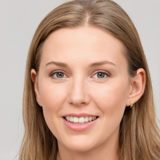 Joyful white young-adult female with long  brown hair and grey eyes