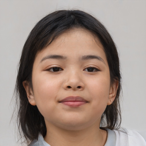 Joyful asian child female with medium  brown hair and brown eyes