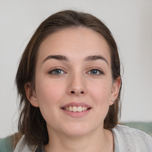 Joyful white young-adult female with medium  brown hair and grey eyes