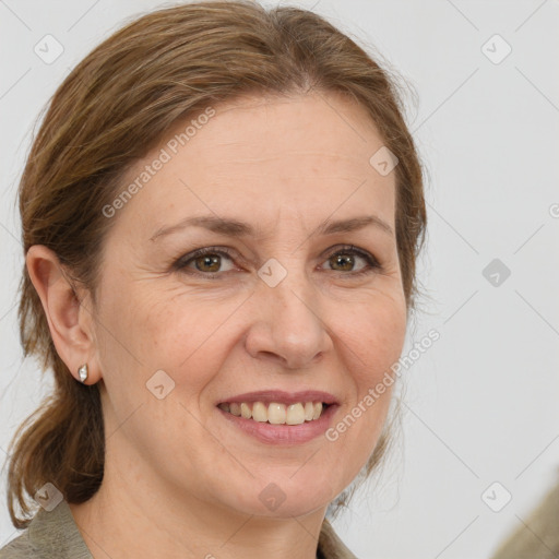 Joyful white adult female with medium  brown hair and green eyes