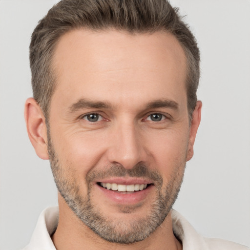 Joyful white adult male with short  brown hair and brown eyes