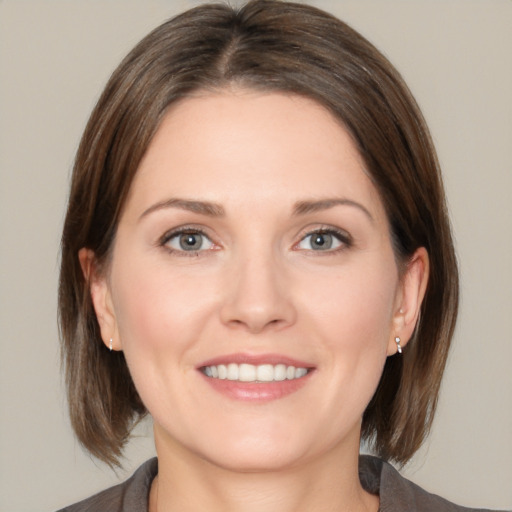 Joyful white young-adult female with medium  brown hair and grey eyes