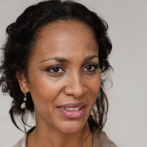 Joyful black adult female with medium  brown hair and brown eyes