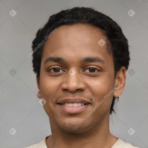 Joyful black young-adult male with short  black hair and brown eyes