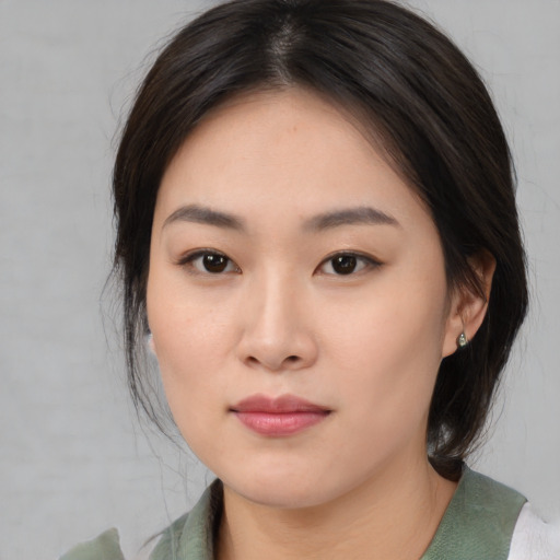 Neutral asian young-adult female with medium  brown hair and brown eyes