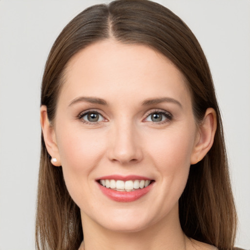 Joyful white young-adult female with long  brown hair and grey eyes