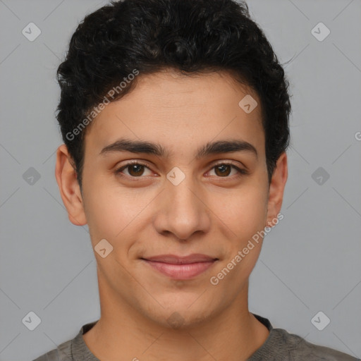 Joyful latino young-adult male with short  brown hair and brown eyes