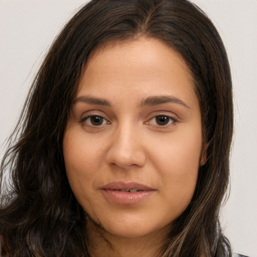 Joyful white young-adult female with long  brown hair and brown eyes