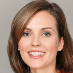 Joyful white young-adult female with medium  brown hair and blue eyes