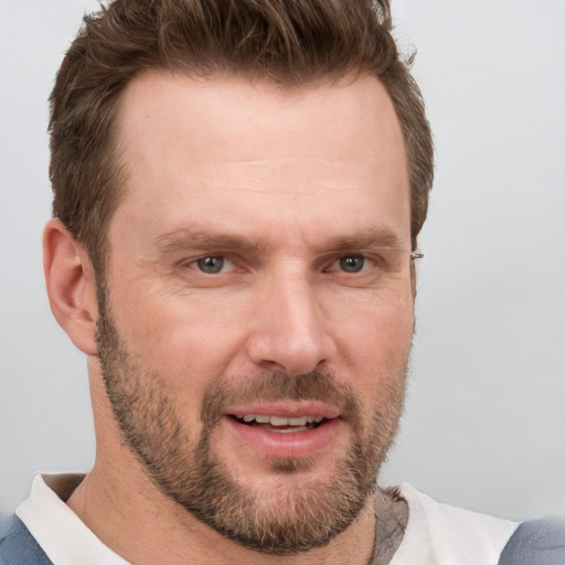 Joyful white adult male with short  brown hair and brown eyes