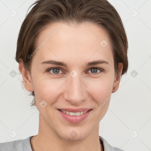 Joyful white young-adult female with short  brown hair and grey eyes