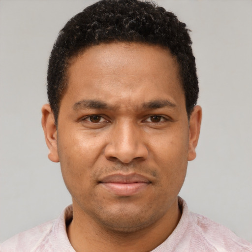 Joyful latino adult male with short  brown hair and brown eyes