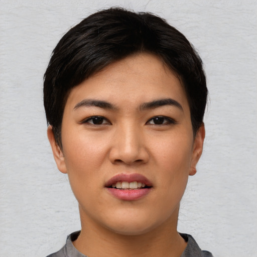 Joyful asian young-adult female with short  black hair and brown eyes