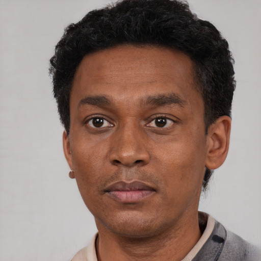 Neutral black adult male with short  black hair and brown eyes