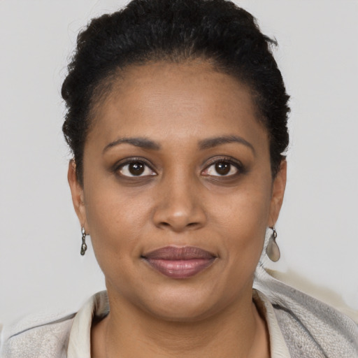 Joyful black young-adult female with short  brown hair and brown eyes