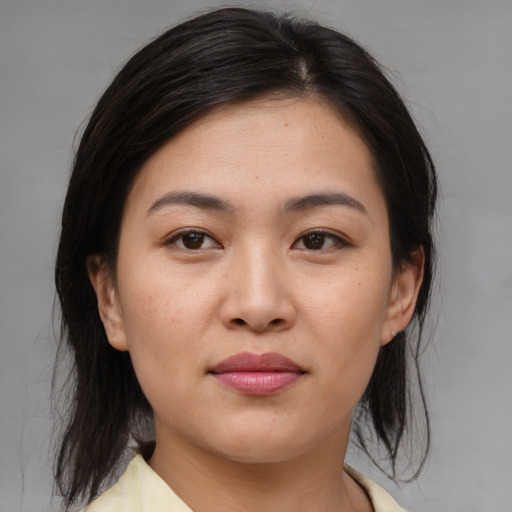 Joyful asian young-adult female with medium  brown hair and brown eyes