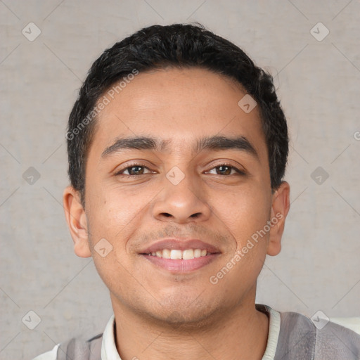 Joyful latino young-adult male with short  black hair and brown eyes