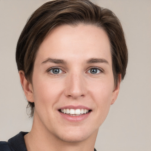 Joyful white young-adult female with short  brown hair and grey eyes