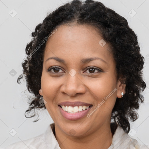 Joyful black young-adult female with medium  brown hair and brown eyes