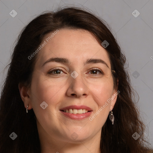 Joyful white adult female with long  brown hair and brown eyes