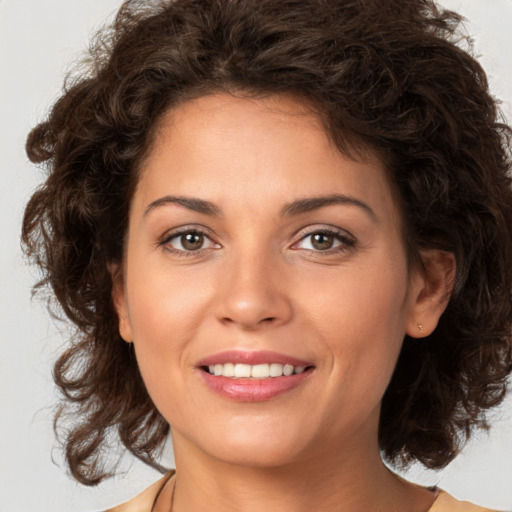 Joyful white young-adult female with medium  brown hair and brown eyes