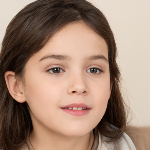 Joyful white child female with long  brown hair and brown eyes