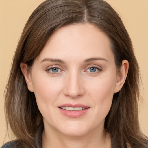 Joyful white young-adult female with long  brown hair and grey eyes