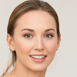 Joyful white young-adult female with medium  brown hair and green eyes