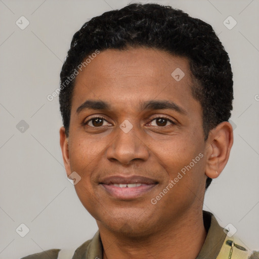 Joyful black adult male with short  black hair and brown eyes