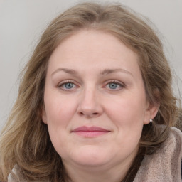 Joyful white adult female with medium  brown hair and grey eyes