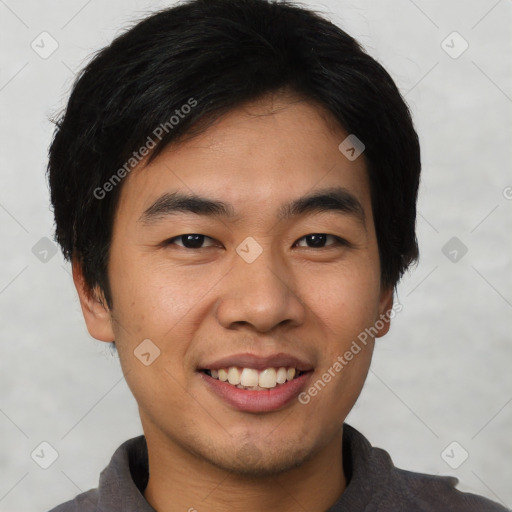 Joyful asian young-adult male with short  black hair and brown eyes