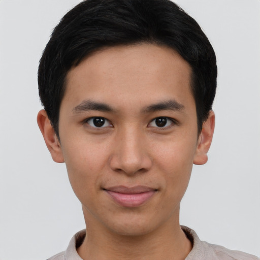 Joyful asian young-adult male with short  brown hair and brown eyes