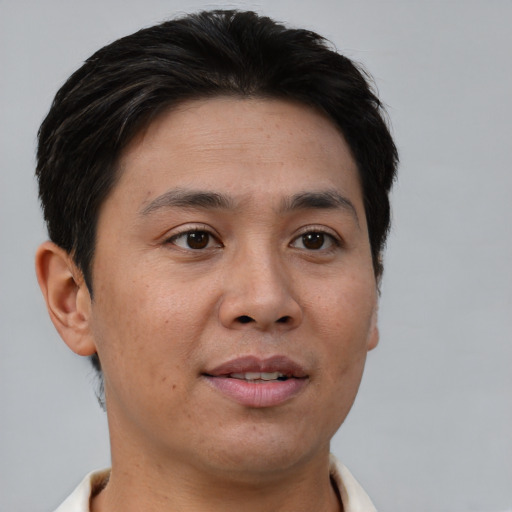 Joyful asian young-adult male with short  brown hair and brown eyes