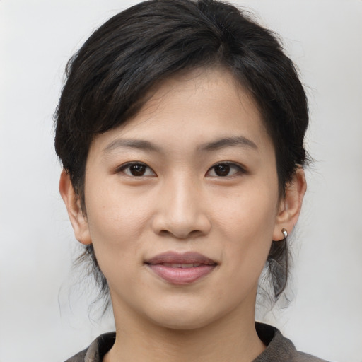 Joyful asian young-adult female with medium  brown hair and brown eyes