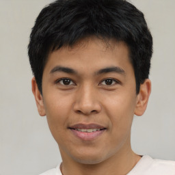 Joyful asian young-adult male with short  black hair and brown eyes