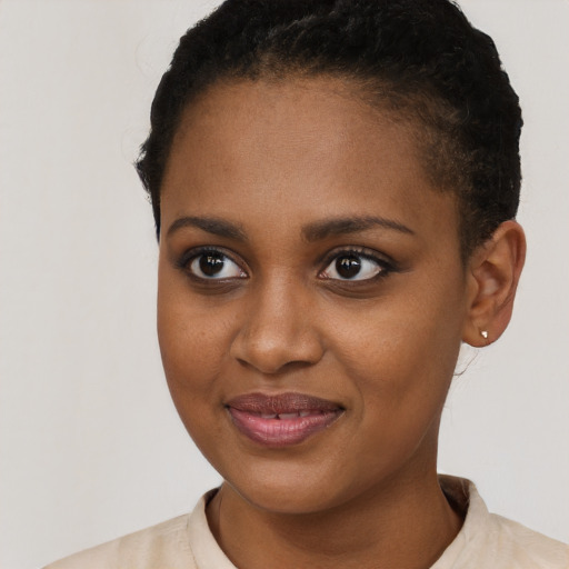 Joyful black young-adult female with short  brown hair and brown eyes